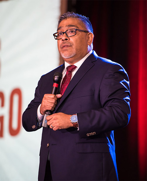 Carlos Samaniego speaking at a national event